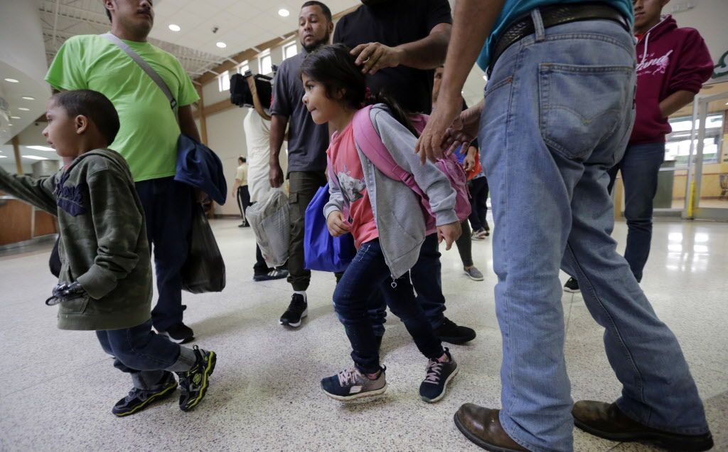 A group of immigrants from Honduras and Guatemala seeking asylum arrive at the bus station after they were processed and released by U.S. Customs and