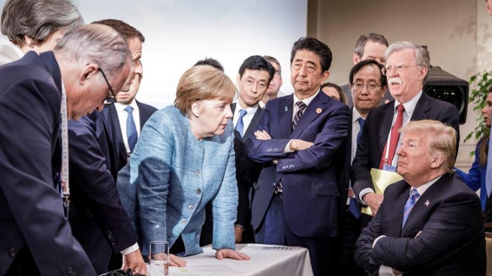 German Chancellor Angela Merkel speaks to U.S. President Donald Trump during the second day of the G7 meeting in Charlevoix city of La Malbaie Quebec Canada