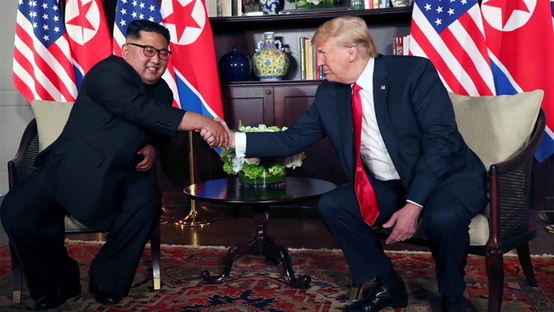 Trump shook hands with Kim before their meeting at the Capella Hotel in Singapore