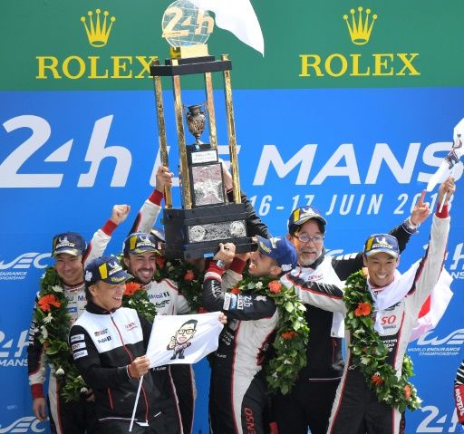 The six drivers from the two Toyota cars celebrated together after finishing first and second at Le MansMore