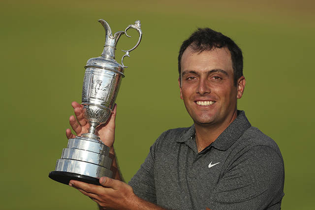 ASSOCIATED PRESS           Francesco Molinari of Italy holds the trophy after winning the British Open Golf Championship in Carnoustie Scotland today