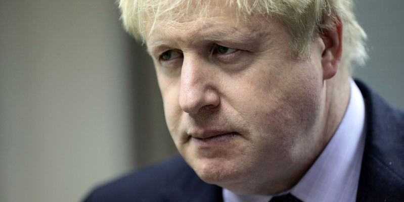 Britain's Foreign Secretary Boris Johnson listens during a visit to a Metropolitan Police wildlife crime unit in London