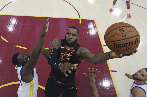 Cleveland Cavaliers Le Bron James shoots against Golden State Warriors Draymond Green during the first half of Game 3 of basketball's NBA Finals Wednesday