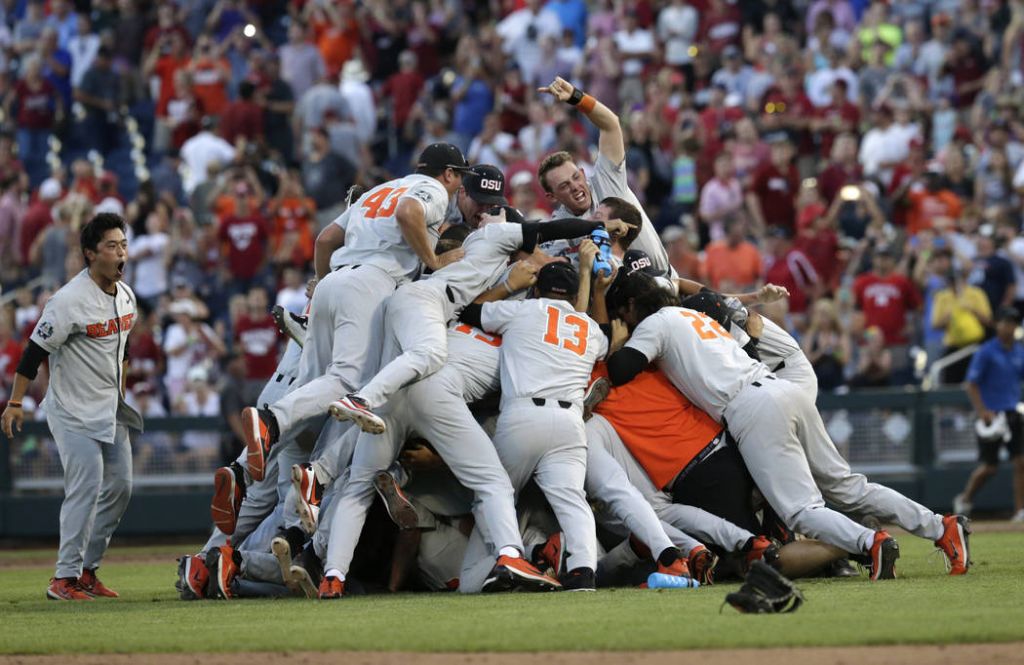 Oregon State players celebrate after they beat Arkansas 5-0 in Game 3 to win the NCAA College World Series baseball finals Thursday