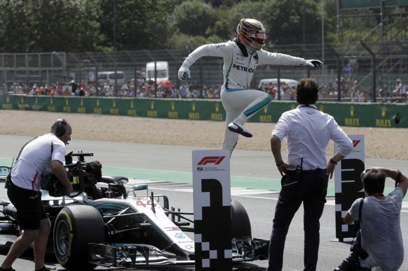 Mercedes driver Lewis Hamilton of Britain celebrates after getting the pole position in the qualifying session for the British Formula One Grand Prix at the Silverstone racetrack Silverstone England Saturday