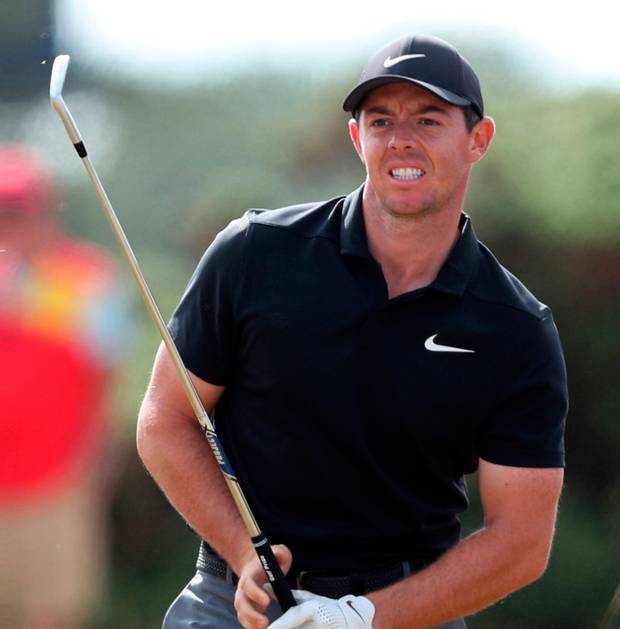 Ireland’s Rory Mc Ilroy hits from the rough on the 14th during day one of The Open