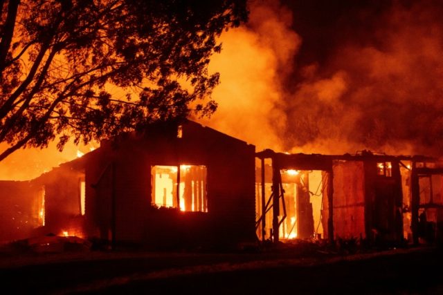 A house burns during the'Carr fire in Redding California which has killed two firefighters and destroyed 65 structures