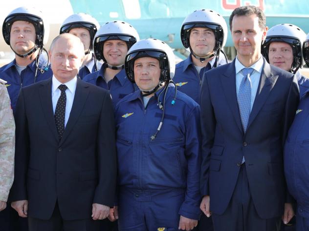 Russian President Vladimir Putin left and Syrian President Bashar Assad right pose for