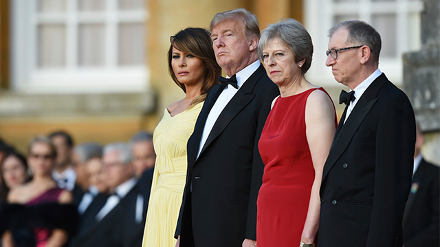 British Prime Minister Theresa May accompanied by her husband Philip right stand with U.S. President Donald Trump and first lady Melania Trump before a black tie dinner at Blenheim Palace in Blenheim England Thursday