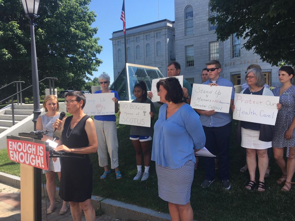 Eliza Townsend executive director of the Maine Women’s Lobby speaks with Rebecca London of Protect Our Care on the left and Nicole Clegg of Planned Parenthood of Northern New England on her right