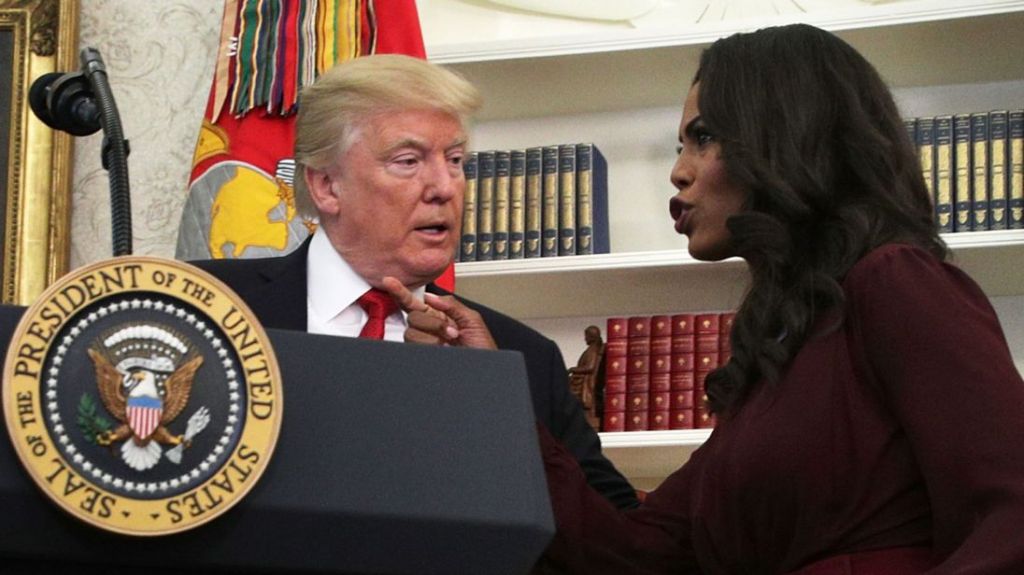 Omarosa Manigault Newman briefs Donald Trump during an event in the Oval Office