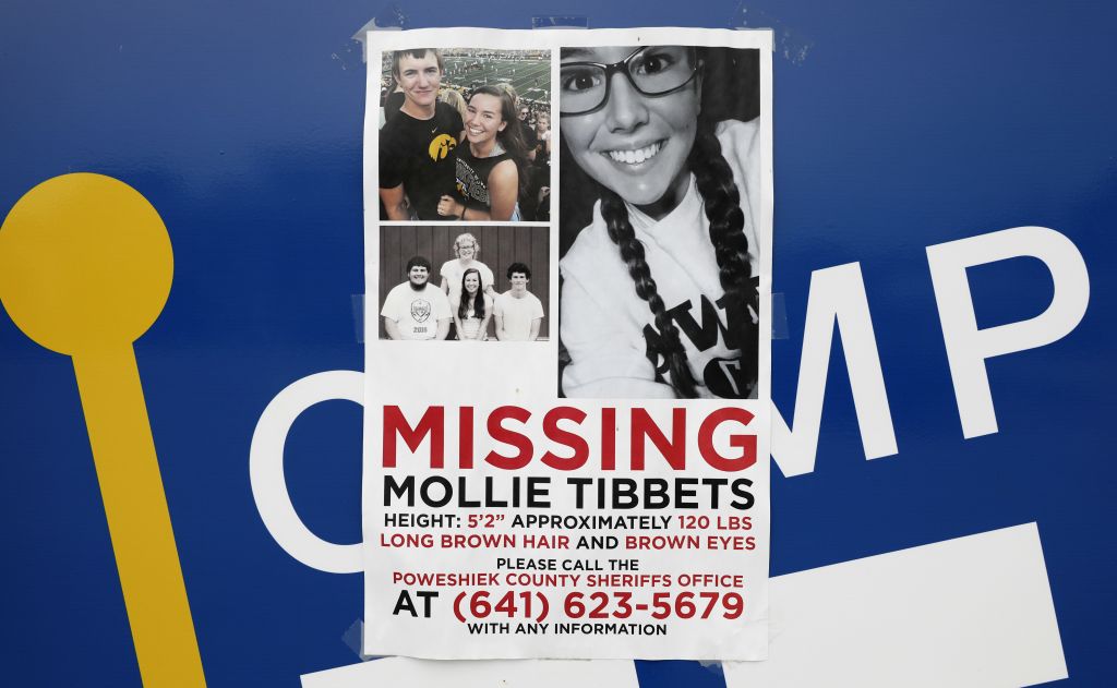 A poster for missing University of Iowa student Mollie Tibbetts hangs on the front door of a local business Tuesday Aug. 21 2018 in Brooklyn Iowa