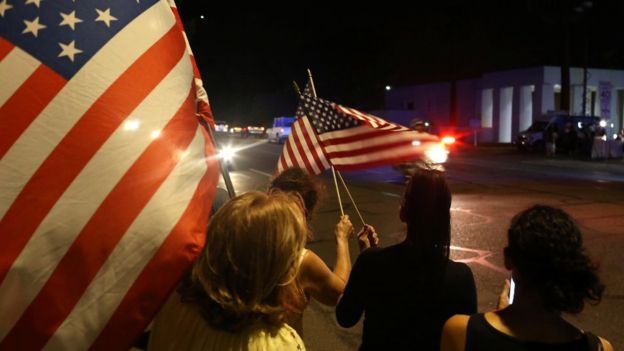 Mourners react as a hearse carrying the body of late U.S. Senator John Mc Cain arrives in a procession in Phoenix Arizona