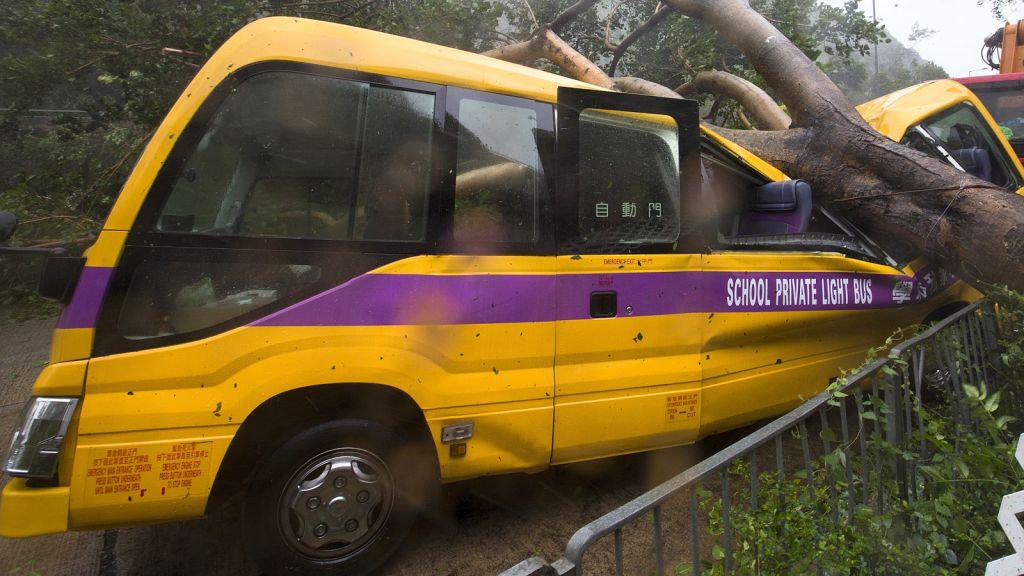 A wrecked school bus in Hong Kong offers testimony to the violence of the storm