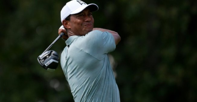 GETTY  AFP | Tiger Woods of the United States plays his shot from the third tee in Newtown Square Pennsylvania