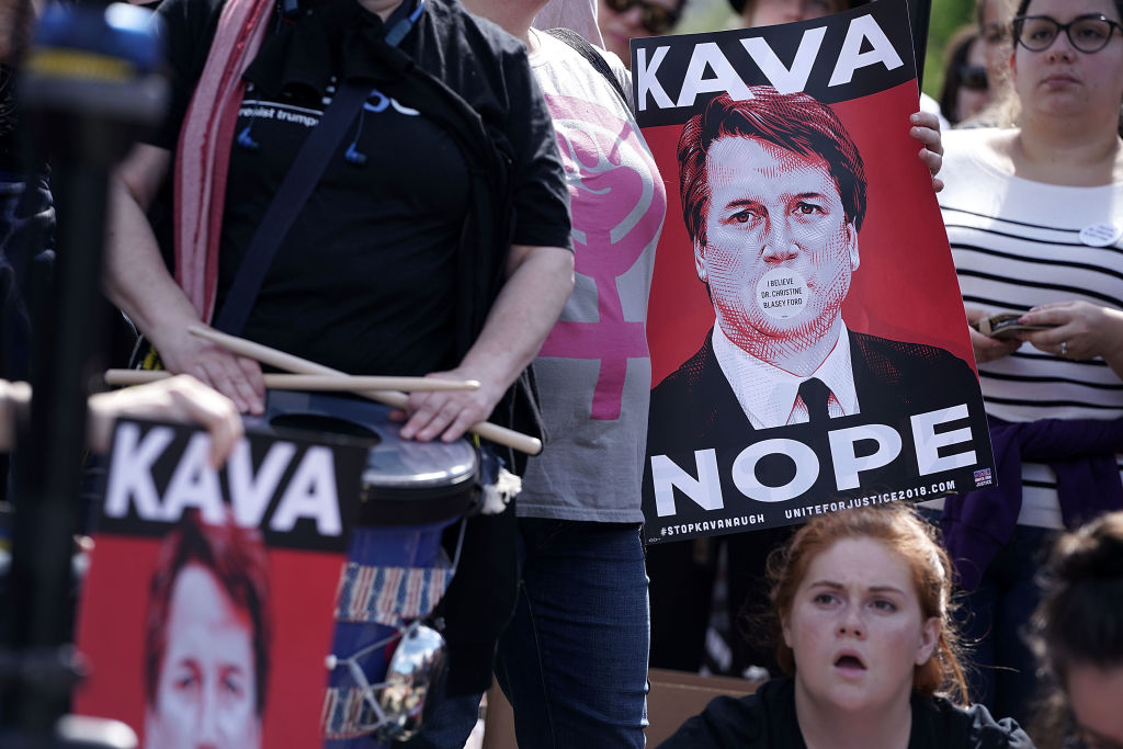 Activists participate in a rally in front of the US Supreme Court