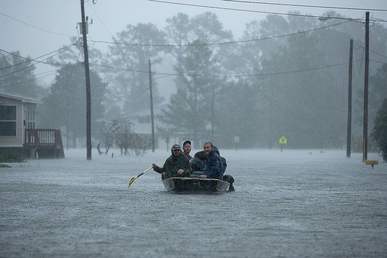 Volunteers rescuing residents from their flooded homes in New Bern North Carolina last Friday. The storm surge had overwhelmed the town of 30,000 which is at the confluence of the Neuse and Trent rivers