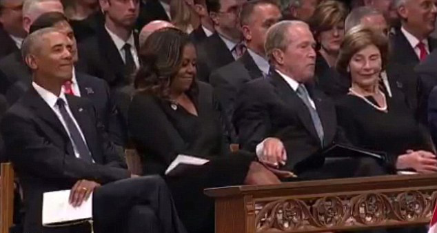 Michelle Obama seemed pleased to be given a share of George Bush’s sweets