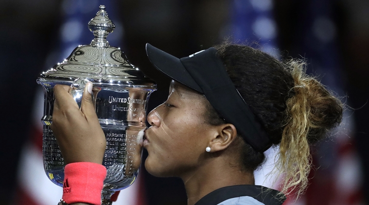 Naomi Osaka of Japan kisses the trophy after defeating Serena Williams in the women's final of the U.S. Open tennis tournament