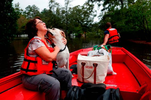 Relief Susan Hedgpeth hugs her dog as they evacuate in Lumberton North Carolina