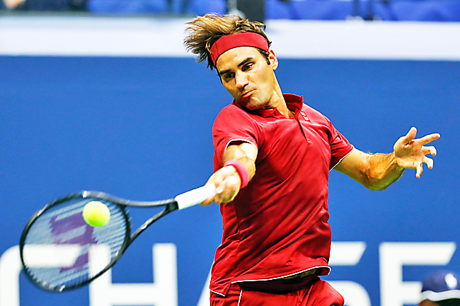 Roger Federer hits a return to Yoshihito Nishioka. – AFP