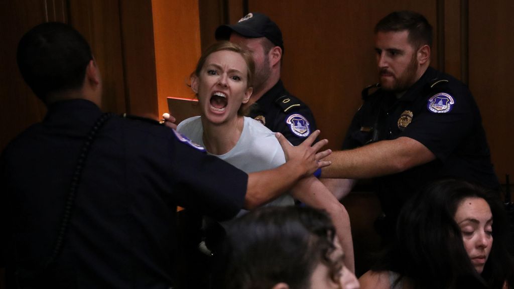 A protester is led away by police after disrupting the second day of the confirmation hearing for Supreme Court nominee Judge Brett Kavanaugh on Capitol Hill on Sept. 5 2018