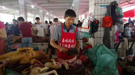 A dog meat butcher at Dongkou market in Yulin