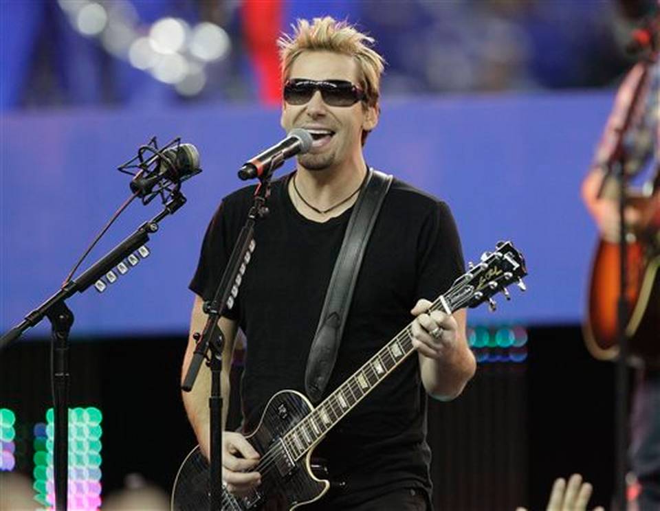 Nickelback lead vocalist Chad Kroeger and his band perform during halftime of an NFL football game between the Detroit Lions and the Green Bay Packers in Detroit. Nickelback is canceling its summer tour as lead sin
