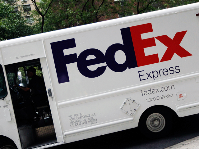 A Fed Ex truck is seen delivering a package