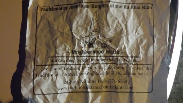 A crinkled up paper shows a message purportedly from the Ku Klux Klan distributed in a predominantly black South Carolina community