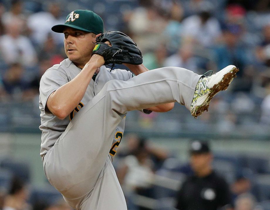 Oakland Athletics pitcher Scott Kazmir comes out of his wind up to deliver against the New York Yankees during the first inning of a baseball game Wednesday