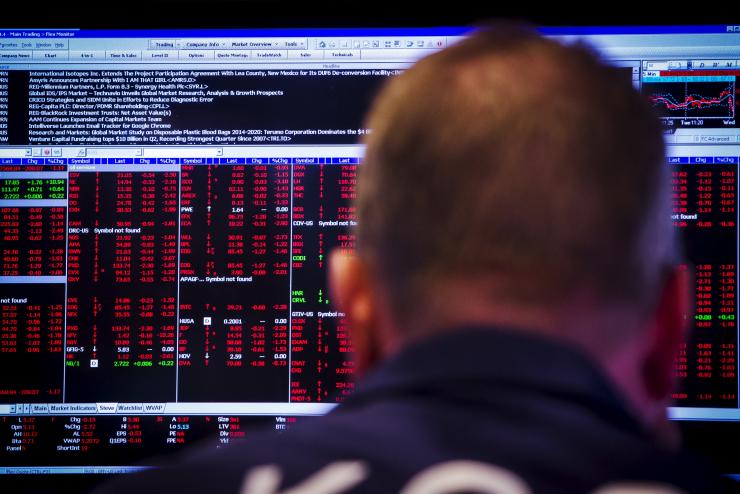 A trader works on the floor of the New York Stock Exchange shortly after the opening bell in New York