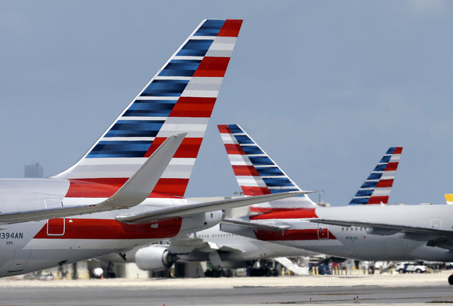 American Airlines aircraft taxi at Miami International Airport in Miami. American Airlines reports quarterly financial results on Friday