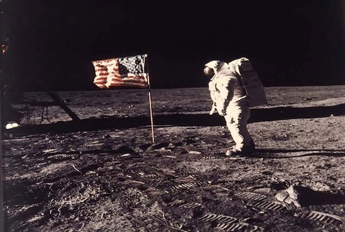 Astronaut Edwin E. Buzz Aldrin Jr. standing beside the U.S. flag deployed on the moon during the Apollo 11 mission