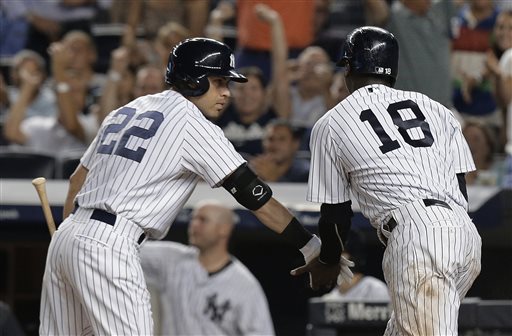 New York Yankees&#039 Jacoby Ellsbury greets Didi Gregorius after Gregorius scored on a double by Brendan Ryan during the sixth inning of a baseball game against the Baltimore Orioles Tuesday