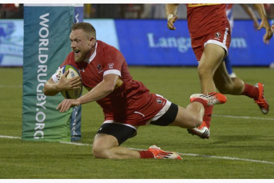 Canada's Phil Mac Kenzie scores a try against Samoa during the second half of their Pacific Nations Cup rugby match Wednesday