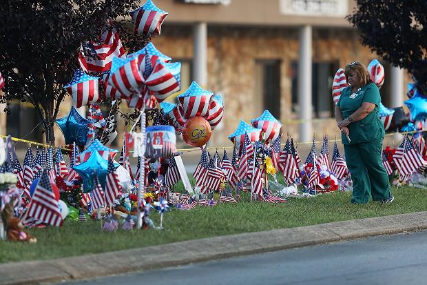 Flowers flags and balloons have been placed in front of the armed forces centre
Joe Raedle