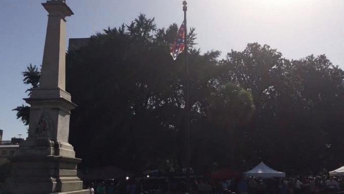 An honor guard from the South Carolina Highway patrol lowers the Confederate battle flag as it is removed from the Capitol grounds Friday in Columbia South Carolina