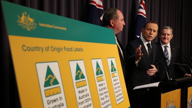 Prime Minister Tony Abbott flanked by Agriculture Minister Barnaby Joyce and Industry minister Ian Macfarlane announce new country of origin food labelling