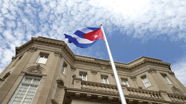 The Cuban national flag is seen raised over their new embassy in Washington yesterday