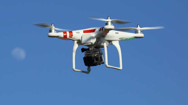 Drone in flight in sky quadcopter UAV aircraft with Go Pro camera quality news image from Flicke Creative Commons uploaded July 22 2015