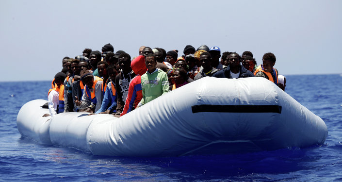 A rubber boat loaded of migrants is seen during a search and rescue mission in the mediterranean sea off the Libyan coasts Italy Tuesday