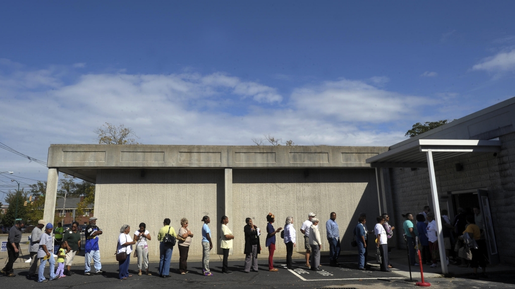 People wait in line to vote at the Board of Elections early voting site on Oct. 18 2012 in Wilson N.C. The U.S. Justice Department and several groups are suing North Carolina over the sweeping election overhaul it passed two years ago