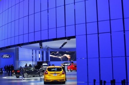 A Ford Mustang and a Focus ST are seen at the Ford display area during the press preview day of the North American International Auto Show in Detroit Michigan