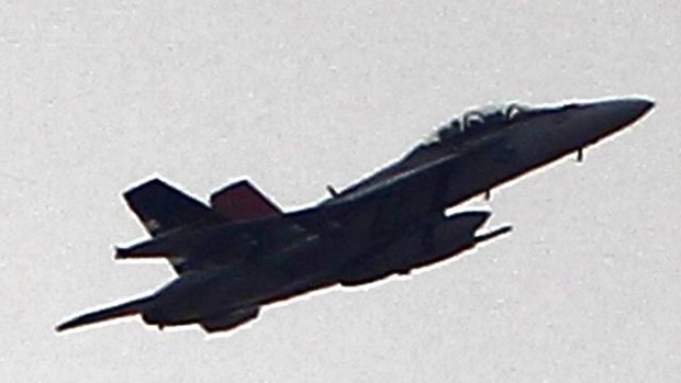 A fighter jet flies above the Syrian town of Kobani on Oct. 19 2014 in Sanliurfa Turkey