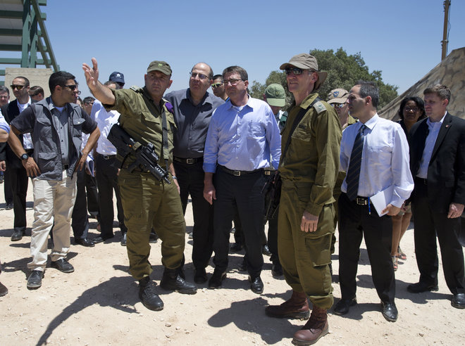 U.S. Defense Secretary Ash Carter walks with William Grant U.S. Embassy Deputy Chief of Mission left and members of his security detail as he arrives at Ben Gurion International Airport in Tel Aviv Israel Sunday