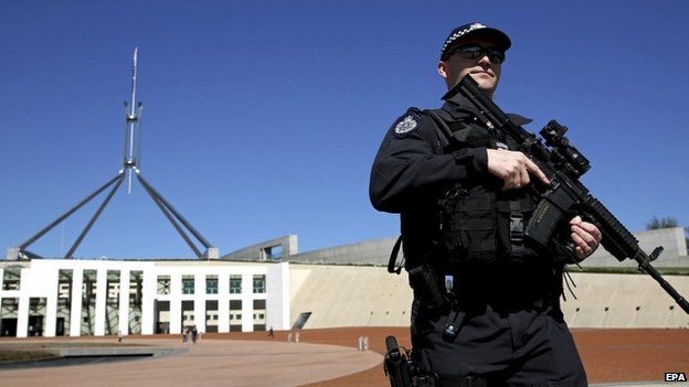 An Australian Federal Police officer patrols in front of Parliament House in Canberra