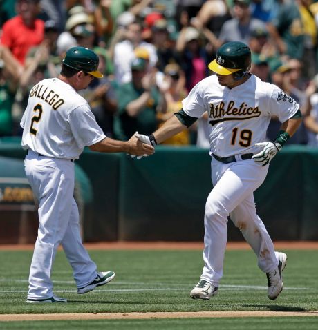 Oakland Athletics Josh Phegley right is congratulated by third base coach Mike Gallego after hitting a two-run home run off Minnesota Twins Tommy Milone in the second inning of a baseball game Sunday