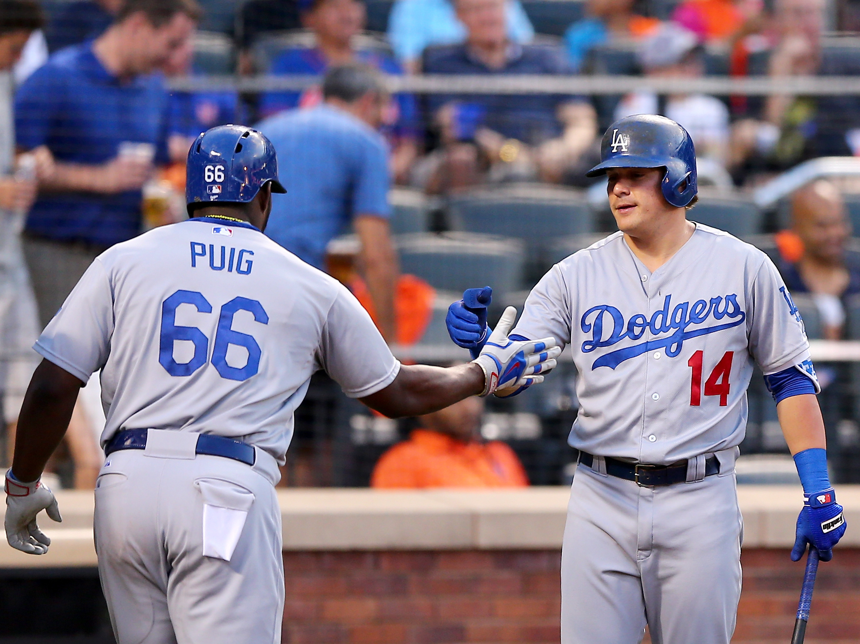 NEW YORK NY- JULY 24 Enrique Hernandez #14 of the Los Angeles Dodgers congratulates teammate Yasiel Puig #66 after Puig hit a two run home run in the third inning against the New York Mets