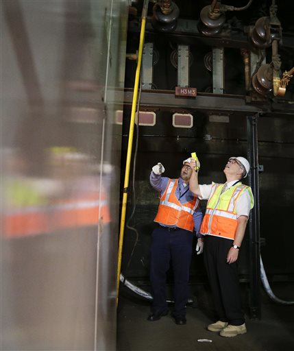 Ray Verrelle left chief engineer for electric traction at Amtrak looks over a termination point with Amtrak president and CEO Joe Boardman beneath Penn Station Friday